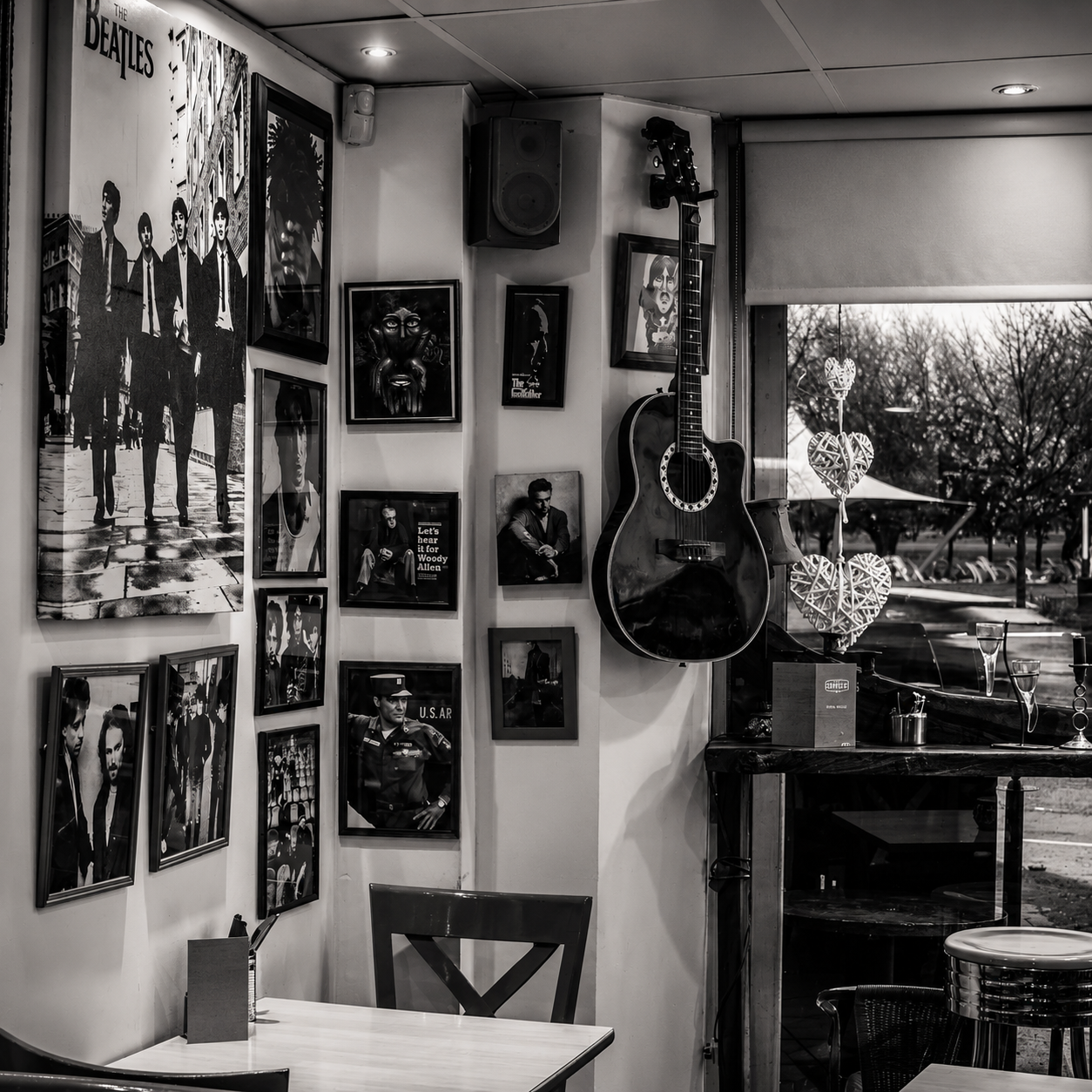 Guitars, framed music artwork and vinyl on the wall inside Javaholics